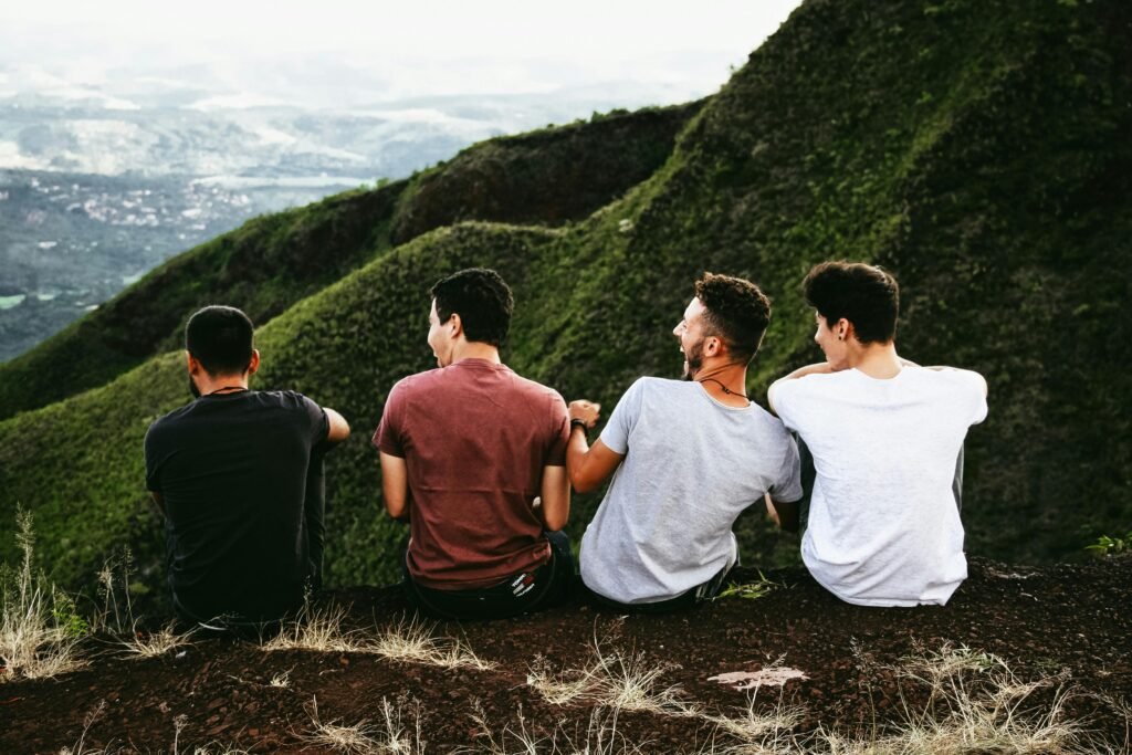 Four friends enjoying a scenic mountain view, symbolizing friendship and adventure. Best hiking with friends quotes.