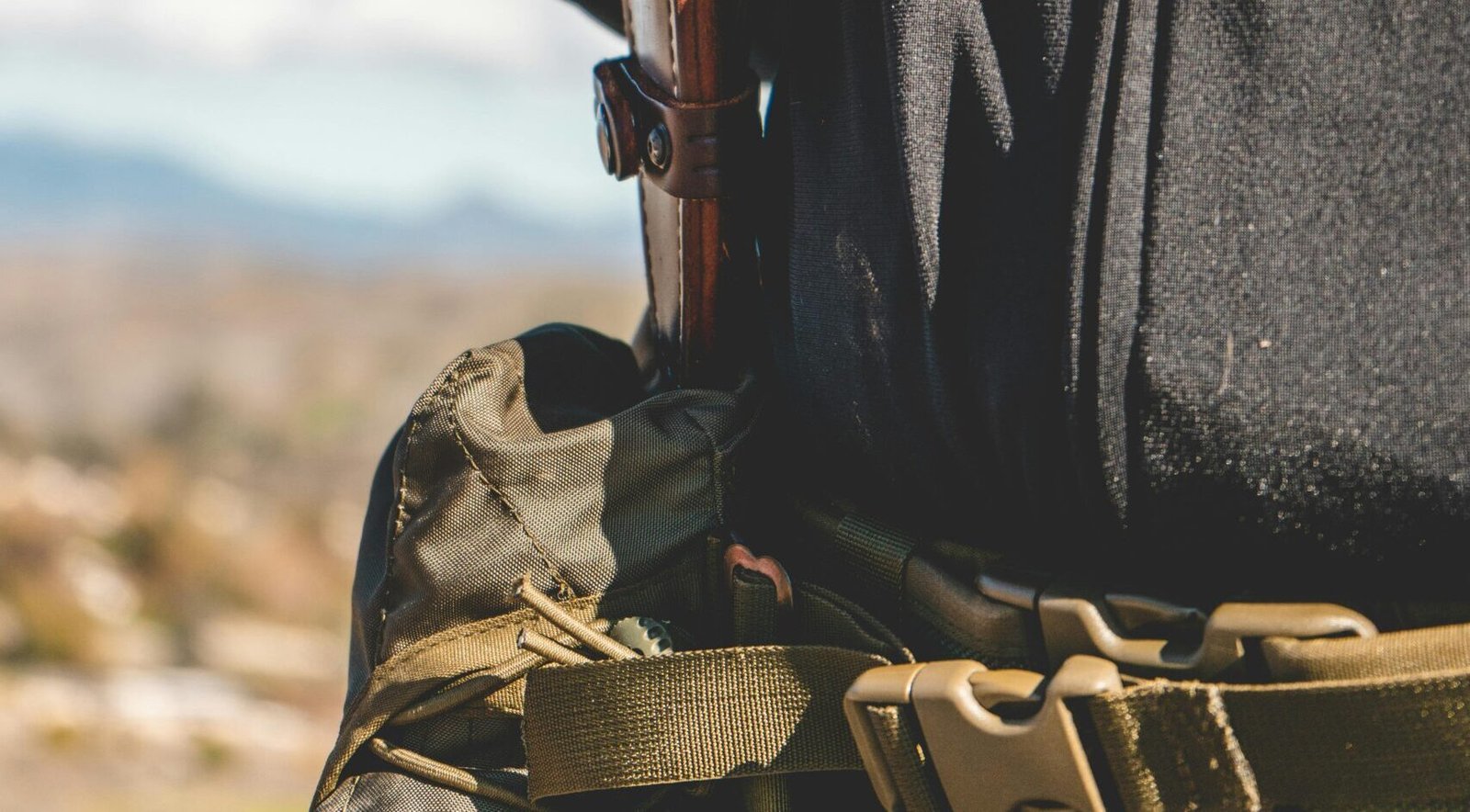 Outdoor adventure with a sturdy tan hiking belt.