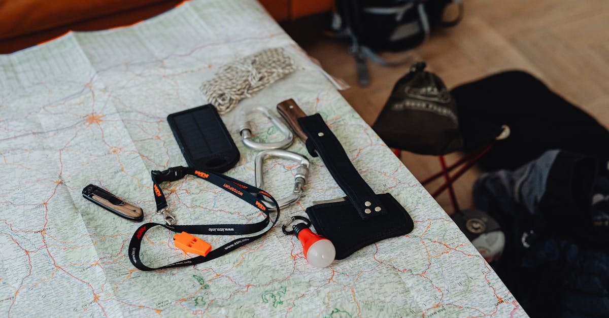 A collection of preparedness tools and gear laid out on a map, ready for an outdoor adventure.