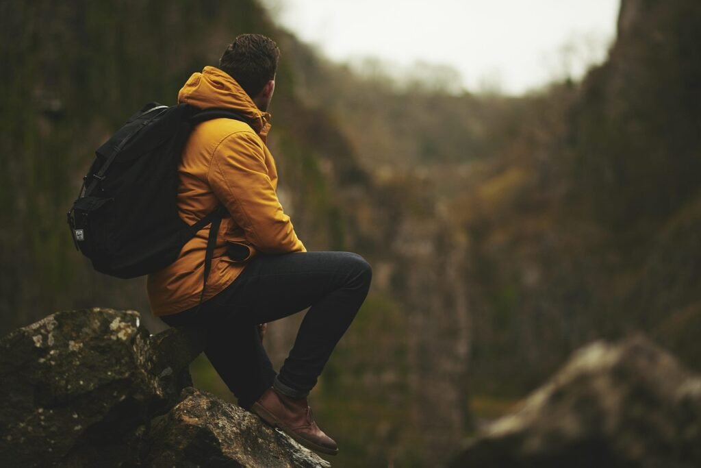 Lost hiker sitting on a rock. What to do if you get lost while hiking.
